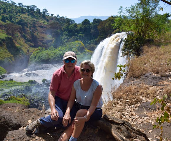 Two people sitting in front of Blue Nile Falls