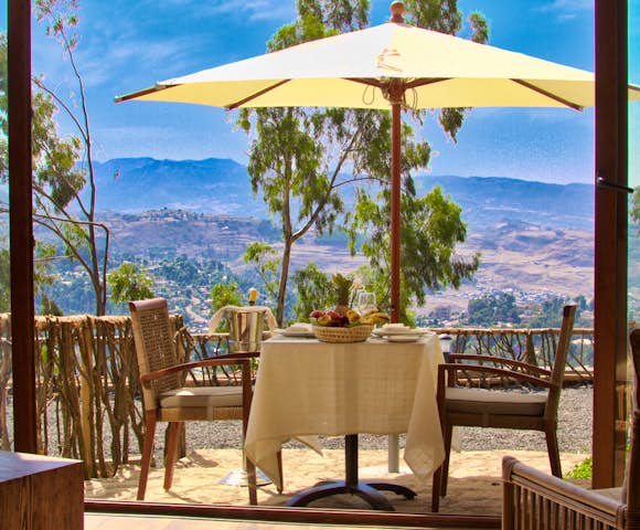 Dining table with mountains in the background at Gondar Hills Resort